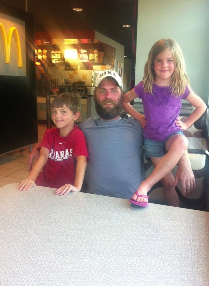 Chris with his son and daughter at a booth, July 2013